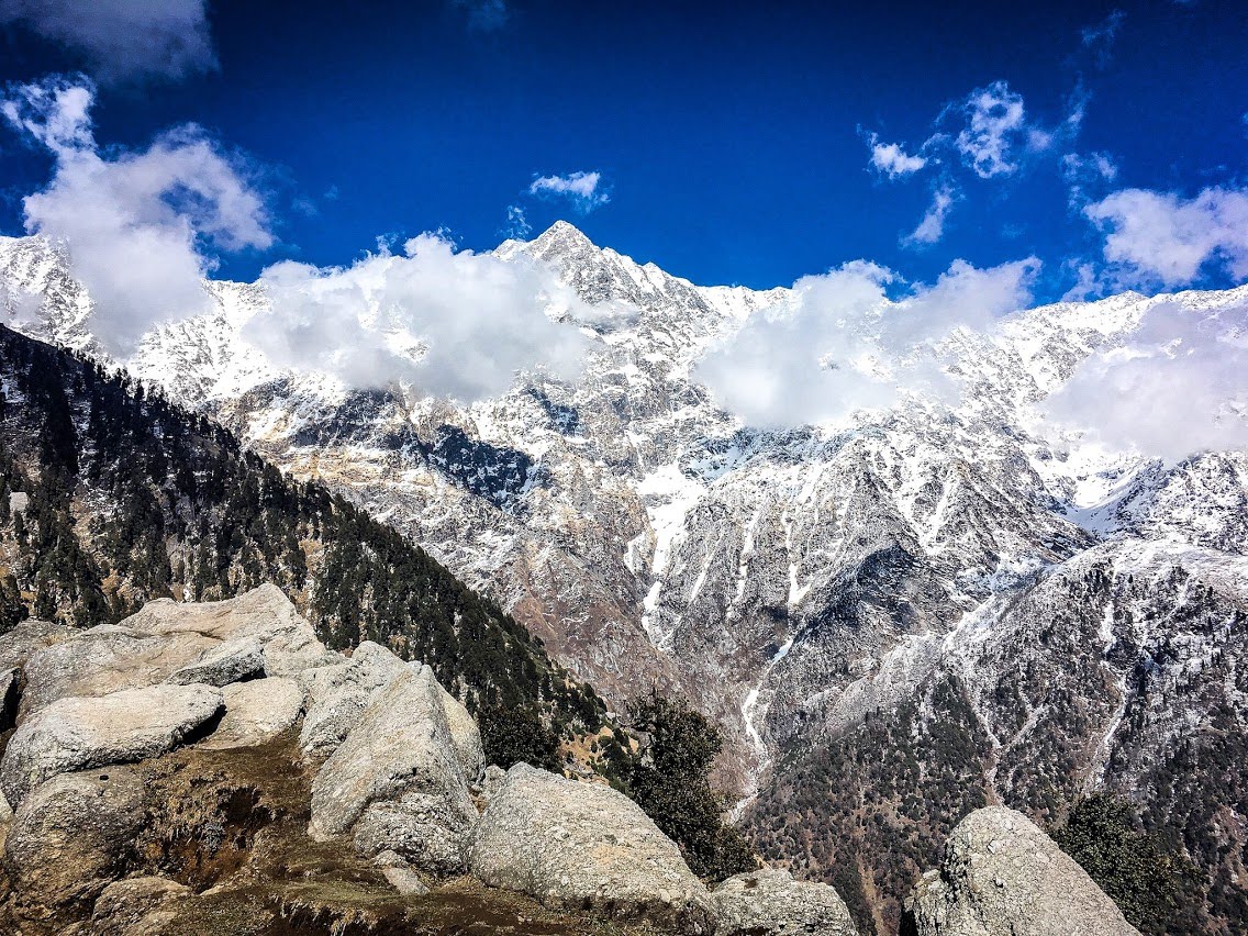 Snow-covered mountains beneath a vivid blue sky